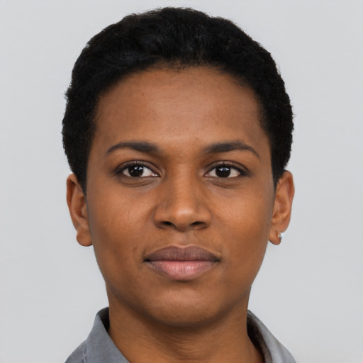 Joyful black young-adult female with short  black hair and brown eyes