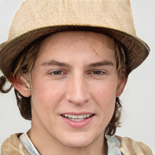 Joyful white young-adult male with short  brown hair and blue eyes