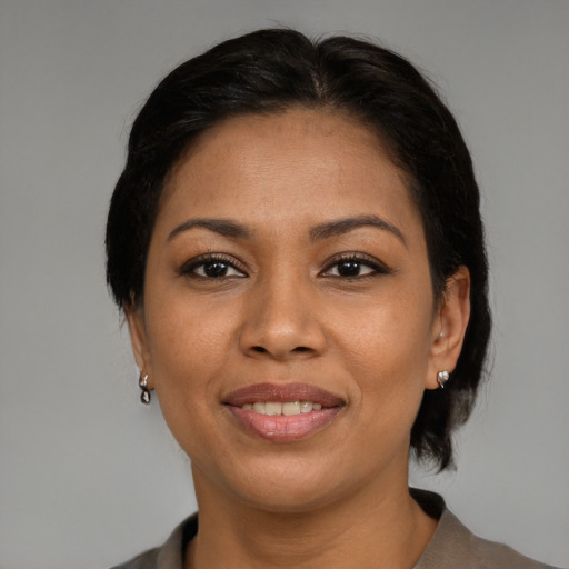 Joyful black young-adult female with medium  brown hair and brown eyes