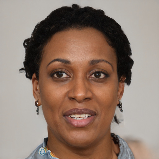 Joyful black adult female with short  brown hair and brown eyes