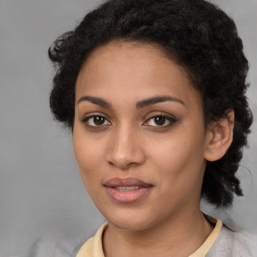 Joyful latino young-adult female with short  black hair and brown eyes