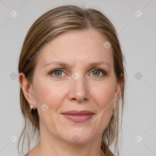 Joyful white adult female with medium  brown hair and grey eyes