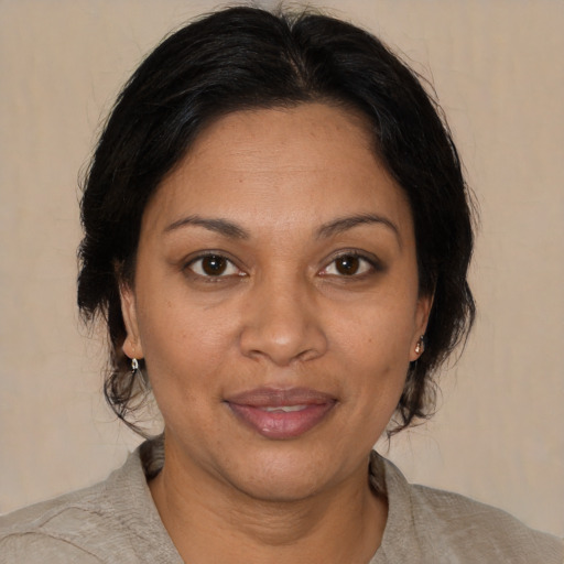 Joyful black adult female with medium  brown hair and brown eyes