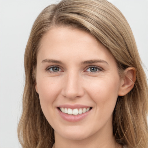 Joyful white young-adult female with long  brown hair and grey eyes