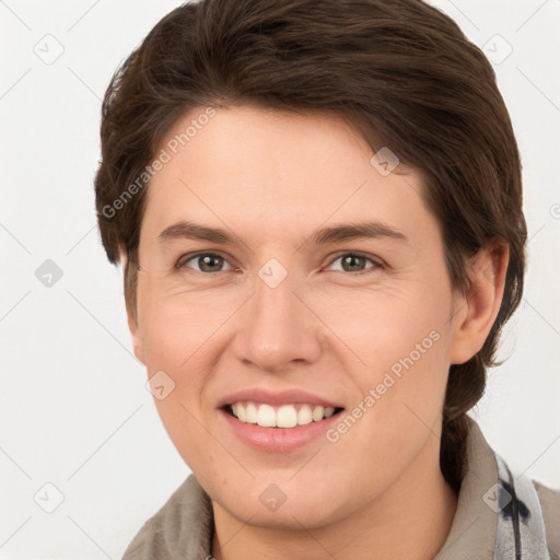 Joyful white young-adult female with short  brown hair and grey eyes