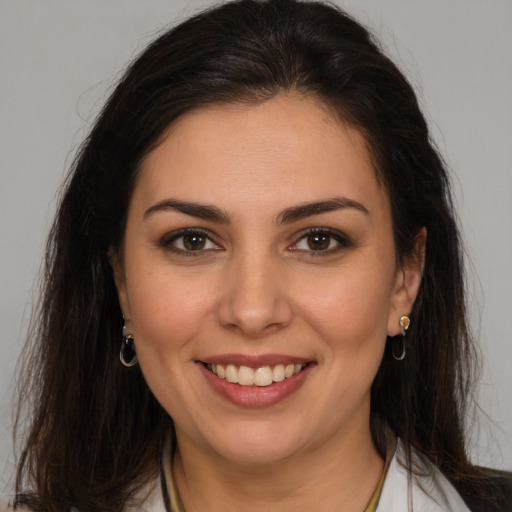 Joyful white young-adult female with long  brown hair and brown eyes