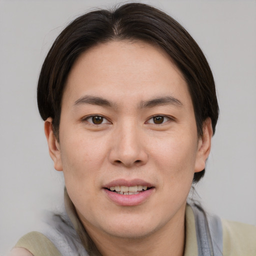 Joyful asian young-adult male with short  brown hair and brown eyes