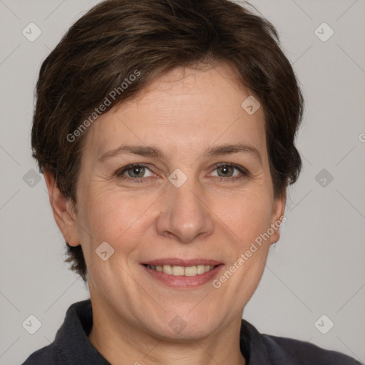 Joyful white adult female with short  brown hair and grey eyes