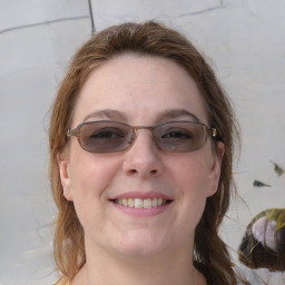 Joyful white young-adult female with medium  brown hair and blue eyes