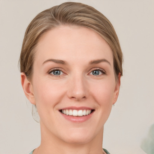 Joyful white young-adult female with short  brown hair and grey eyes