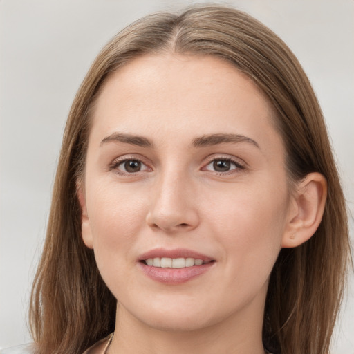 Joyful white young-adult female with long  brown hair and grey eyes