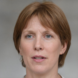 Joyful white adult female with medium  brown hair and grey eyes