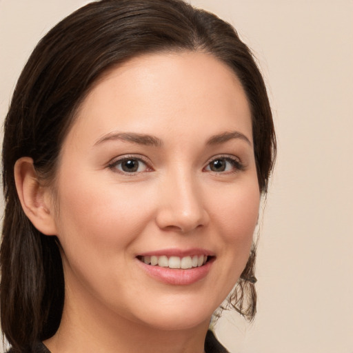 Joyful white young-adult female with medium  brown hair and brown eyes