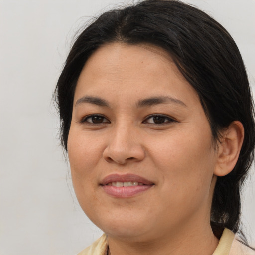 Joyful asian young-adult female with medium  brown hair and brown eyes