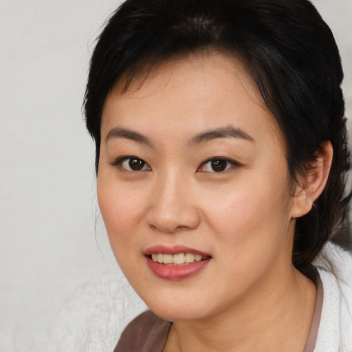 Joyful asian young-adult female with medium  brown hair and brown eyes