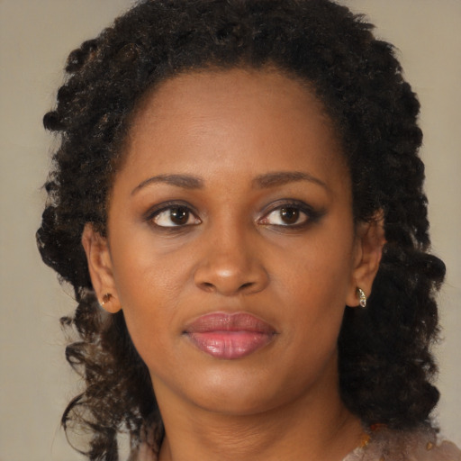 Joyful black young-adult female with medium  brown hair and brown eyes