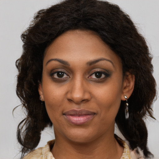 Joyful black young-adult female with medium  brown hair and brown eyes