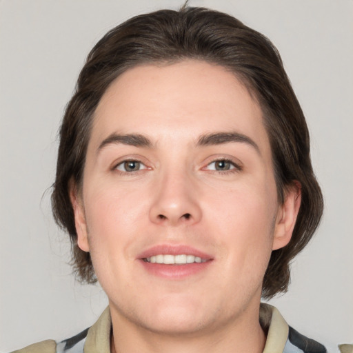 Joyful white young-adult female with medium  brown hair and grey eyes