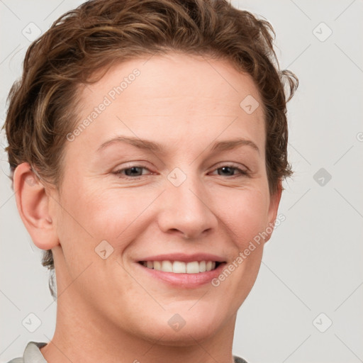 Joyful white adult female with short  brown hair and blue eyes