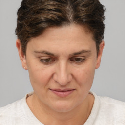 Joyful white adult female with short  brown hair and brown eyes