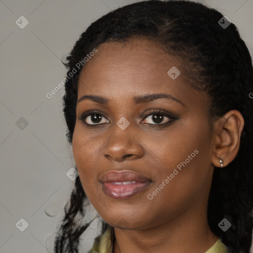 Joyful black young-adult female with long  black hair and brown eyes