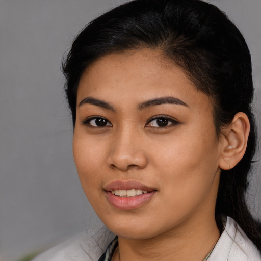 Joyful latino young-adult female with medium  black hair and brown eyes