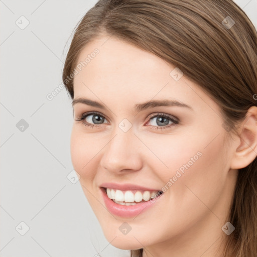 Joyful white young-adult female with long  brown hair and grey eyes