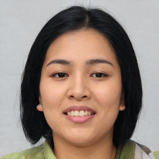 Joyful asian young-adult female with medium  black hair and brown eyes