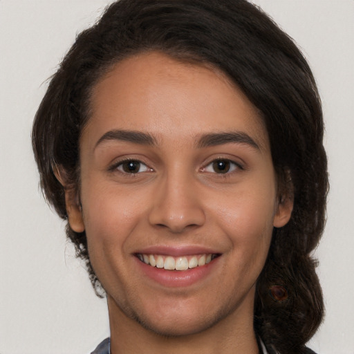 Joyful white young-adult female with long  brown hair and brown eyes