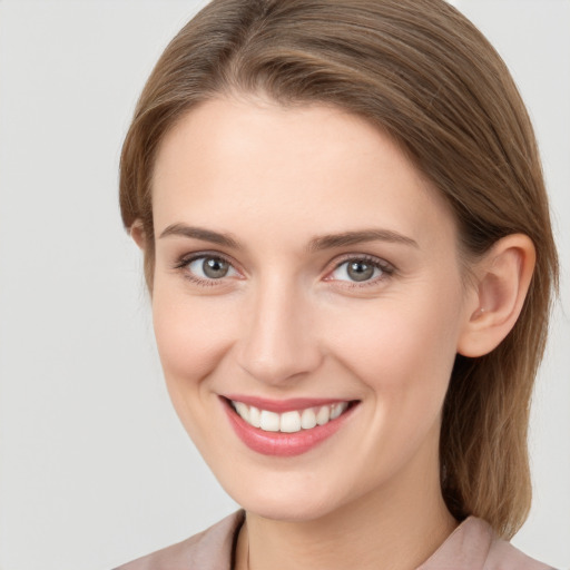 Joyful white young-adult female with long  brown hair and grey eyes