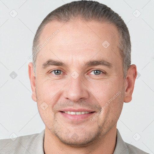 Joyful white adult male with short  brown hair and grey eyes