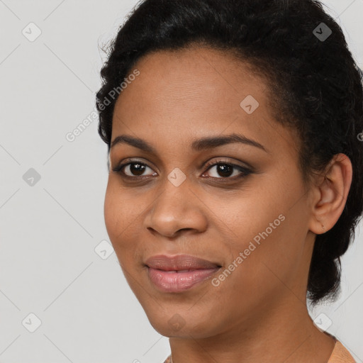 Joyful black young-adult female with short  black hair and brown eyes