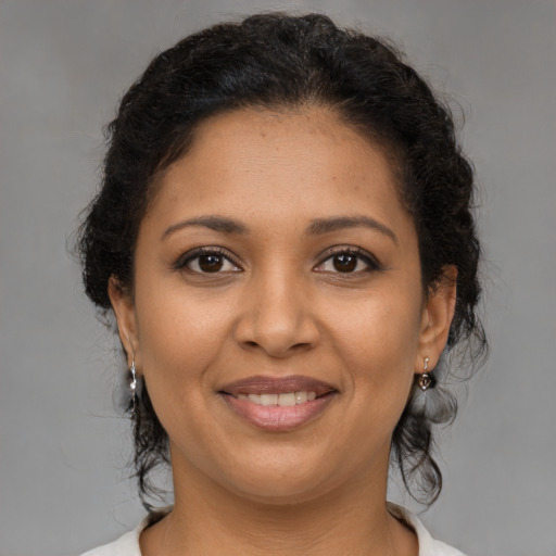 Joyful latino young-adult female with medium  brown hair and brown eyes