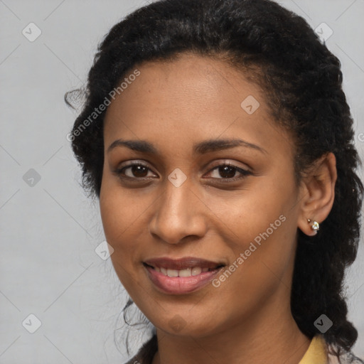 Joyful black young-adult female with long  brown hair and brown eyes