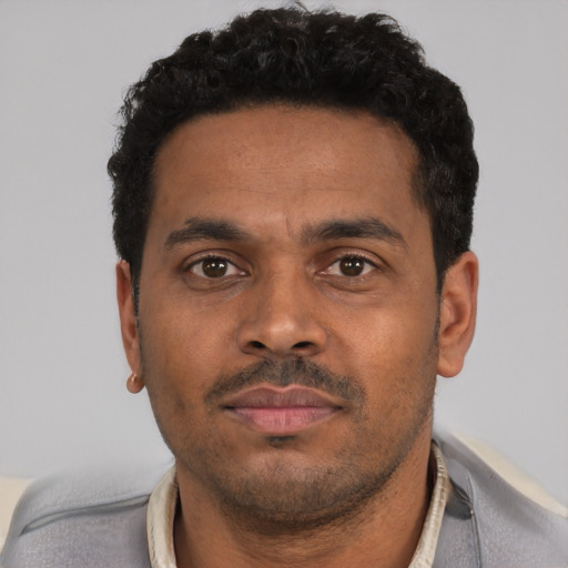 Neutral black young-adult male with short  black hair and brown eyes