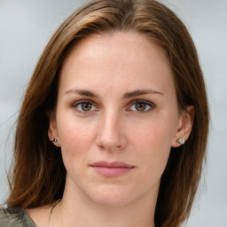 Joyful white young-adult female with medium  brown hair and green eyes