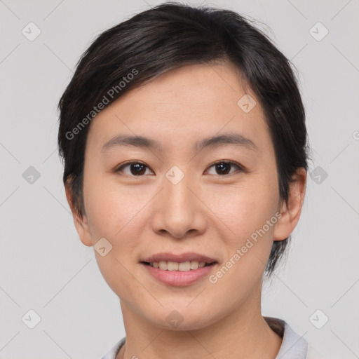 Joyful asian young-adult female with short  brown hair and brown eyes