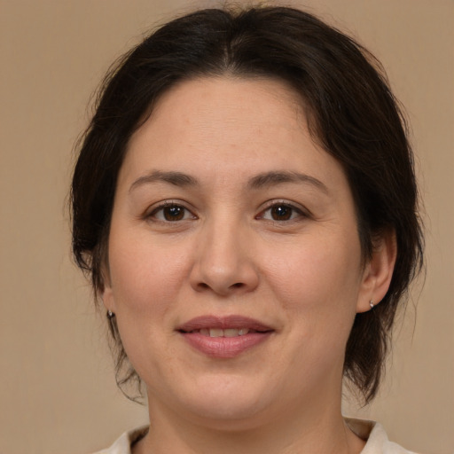 Joyful white adult female with medium  brown hair and brown eyes