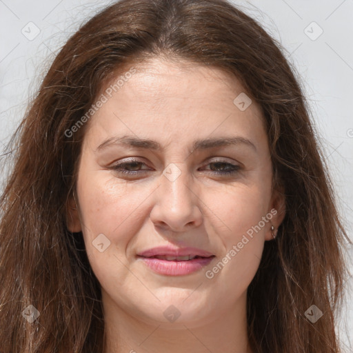 Joyful white adult female with long  brown hair and brown eyes