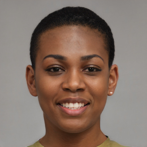 Joyful black young-adult female with short  brown hair and brown eyes