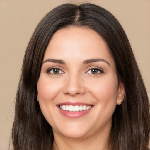 Joyful white young-adult female with long  brown hair and brown eyes