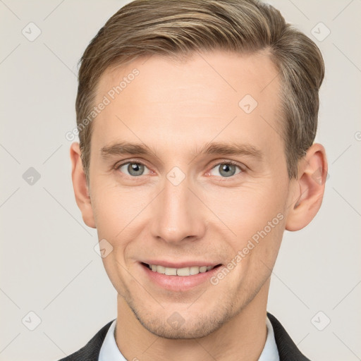 Joyful white adult male with short  brown hair and grey eyes