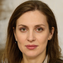 Joyful white young-adult female with long  brown hair and green eyes