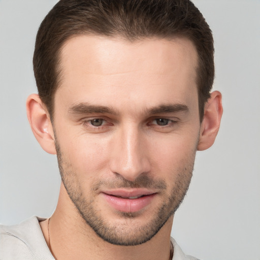 Joyful white young-adult male with short  brown hair and grey eyes