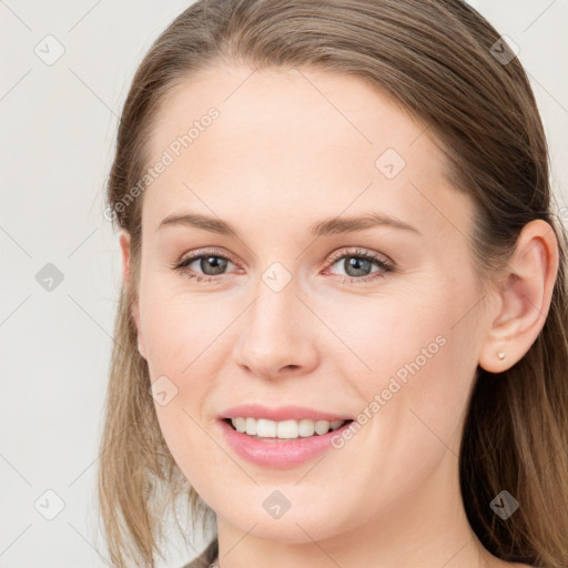 Joyful white young-adult female with long  brown hair and grey eyes