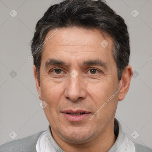 Joyful white adult male with short  black hair and brown eyes