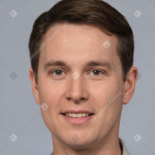 Joyful white adult male with short  brown hair and grey eyes