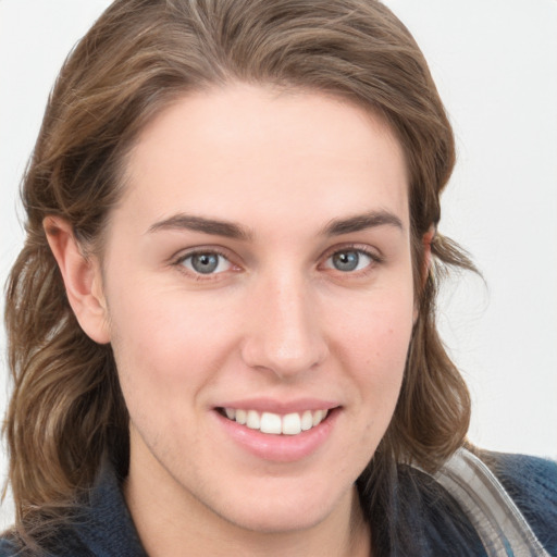 Joyful white young-adult female with long  brown hair and blue eyes