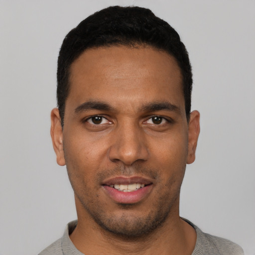 Joyful white young-adult male with short  black hair and brown eyes