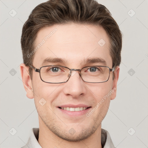 Joyful white young-adult male with short  brown hair and grey eyes